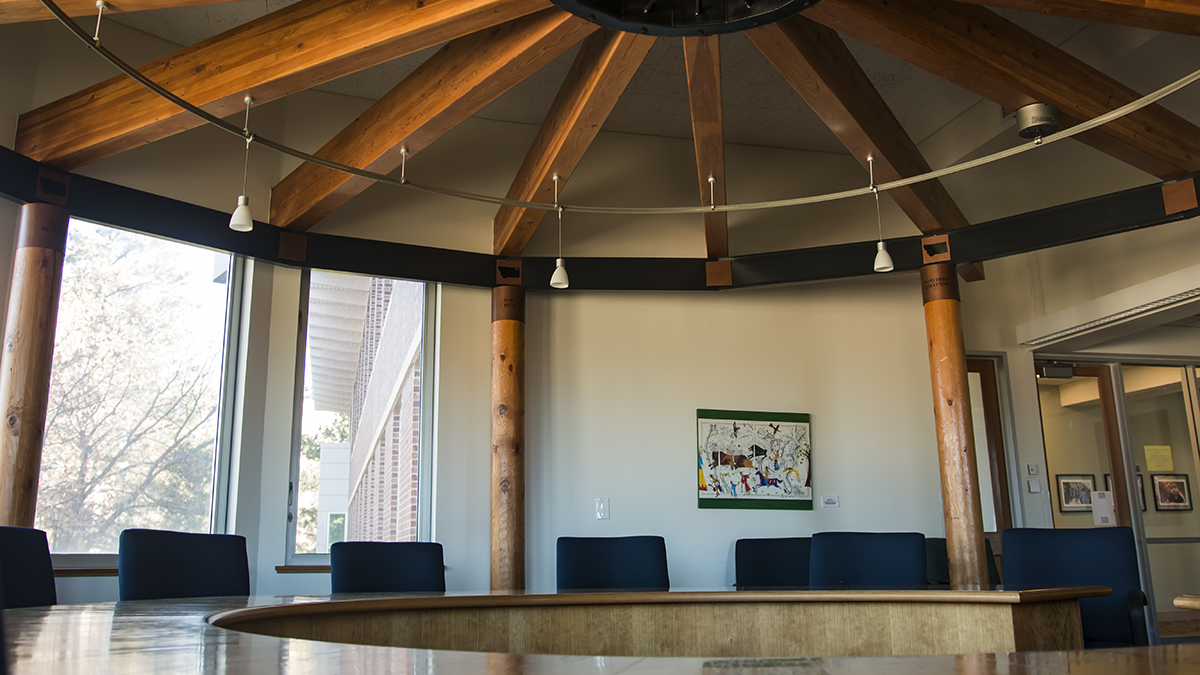 The A.B. Guthrie Reading Room in Don Anderson Hall features a round conference table surrounded by windows.