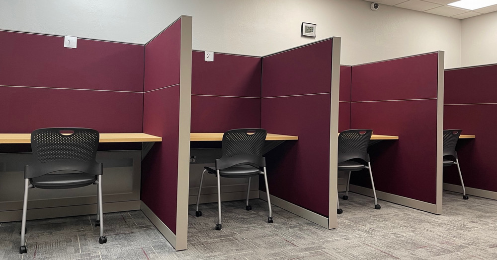 Cubicle workstation desks and chairs in the group testing room provide a quiet, distraction-reduced environment.