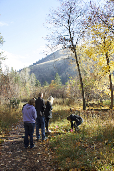 Photo of students collecting data from a well with Mt. Jumbo in the background.