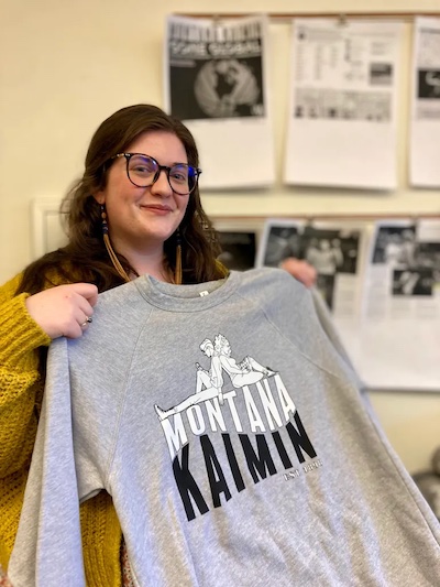 Woman with dark hair looks at camera and displays a Montana Kaimin sweatshirt.