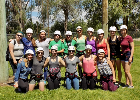 Participants wearing helmets and climbing gear.