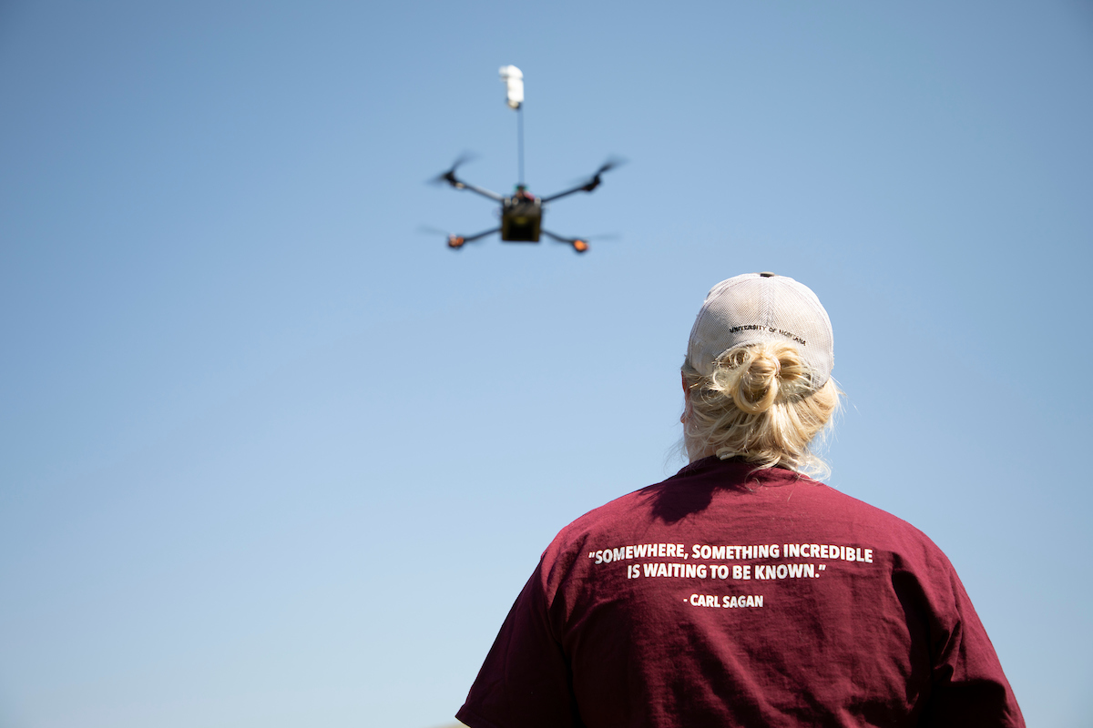 Photo of student operating a drone
