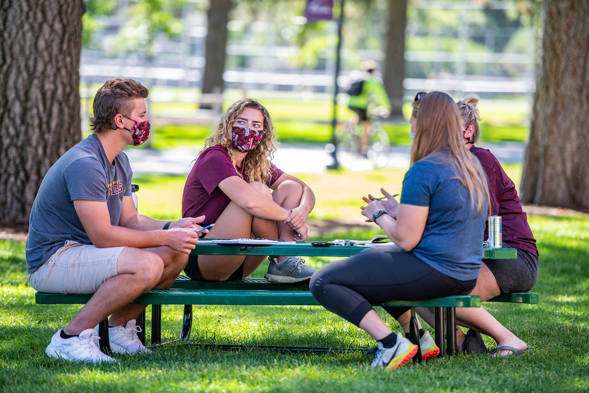 Photo of students at picnic table