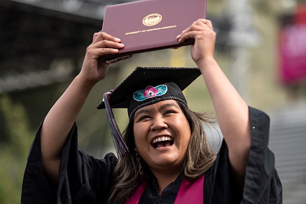 Photo of graduate with diploma