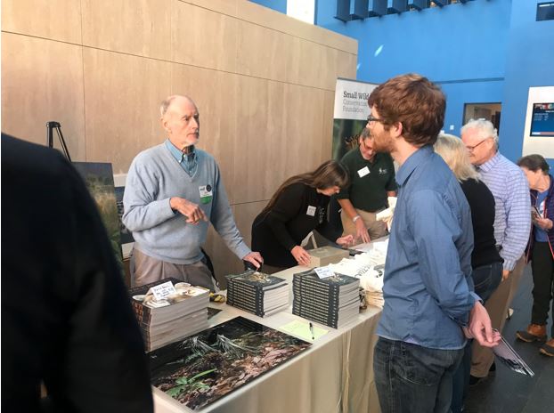 The Samll Wild Cat Conservation Foundationbooth. Dr. Jim Sanderson is seen in the picture talking to a small cat enthusiast