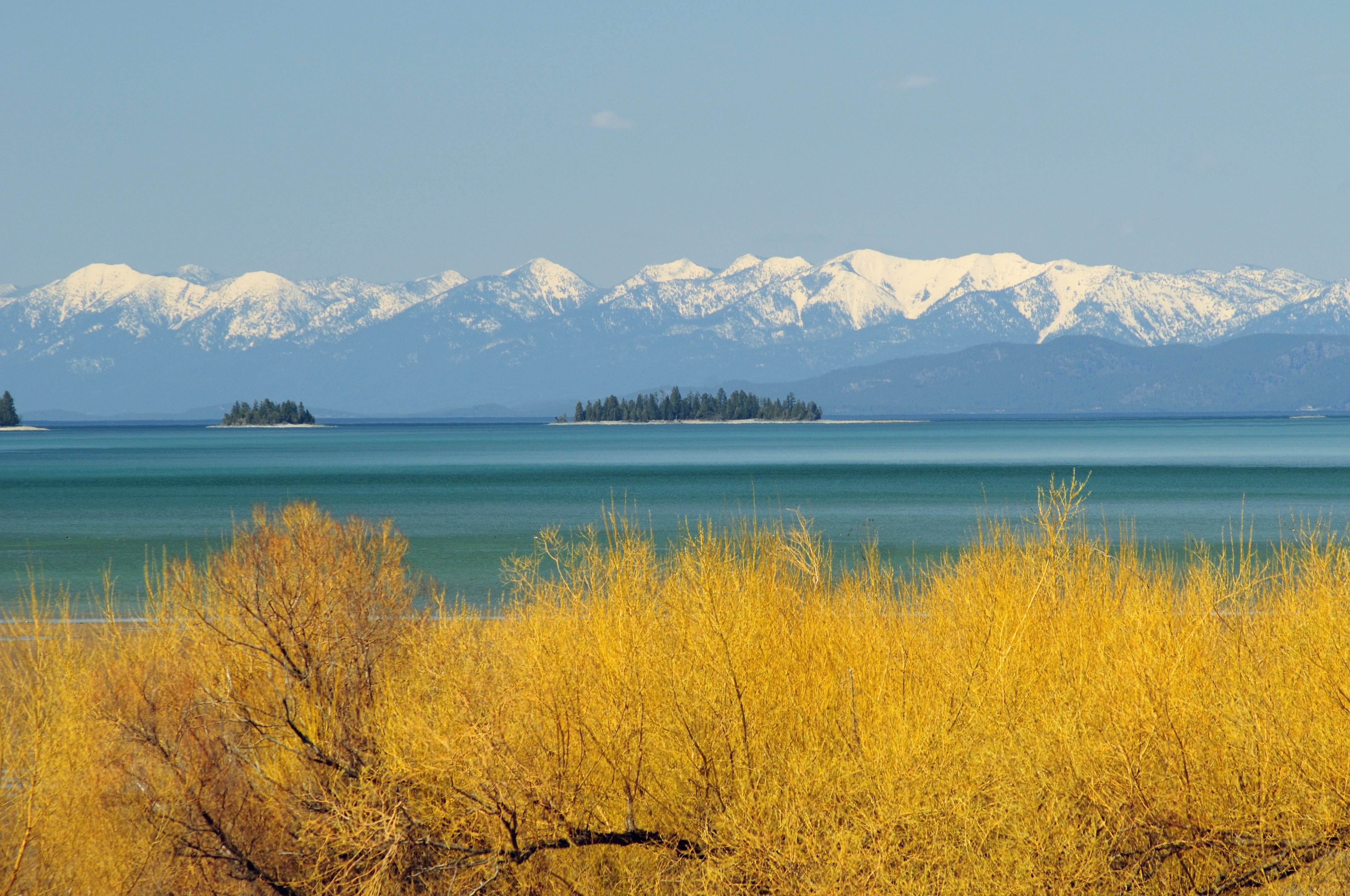 Spring comes to Flathead Lake while the Swan Range is still cloaked in winter.