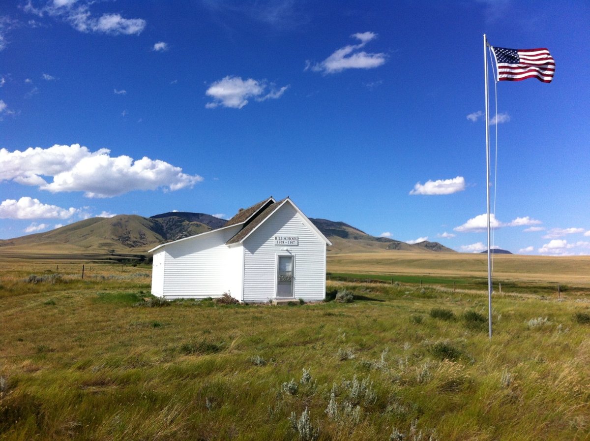Hill School, recently rehabilitated with a Preserve Montana Fund grant, proudly shines against the Montana landscape. (Photo by the Montana Preservation Alliance) 