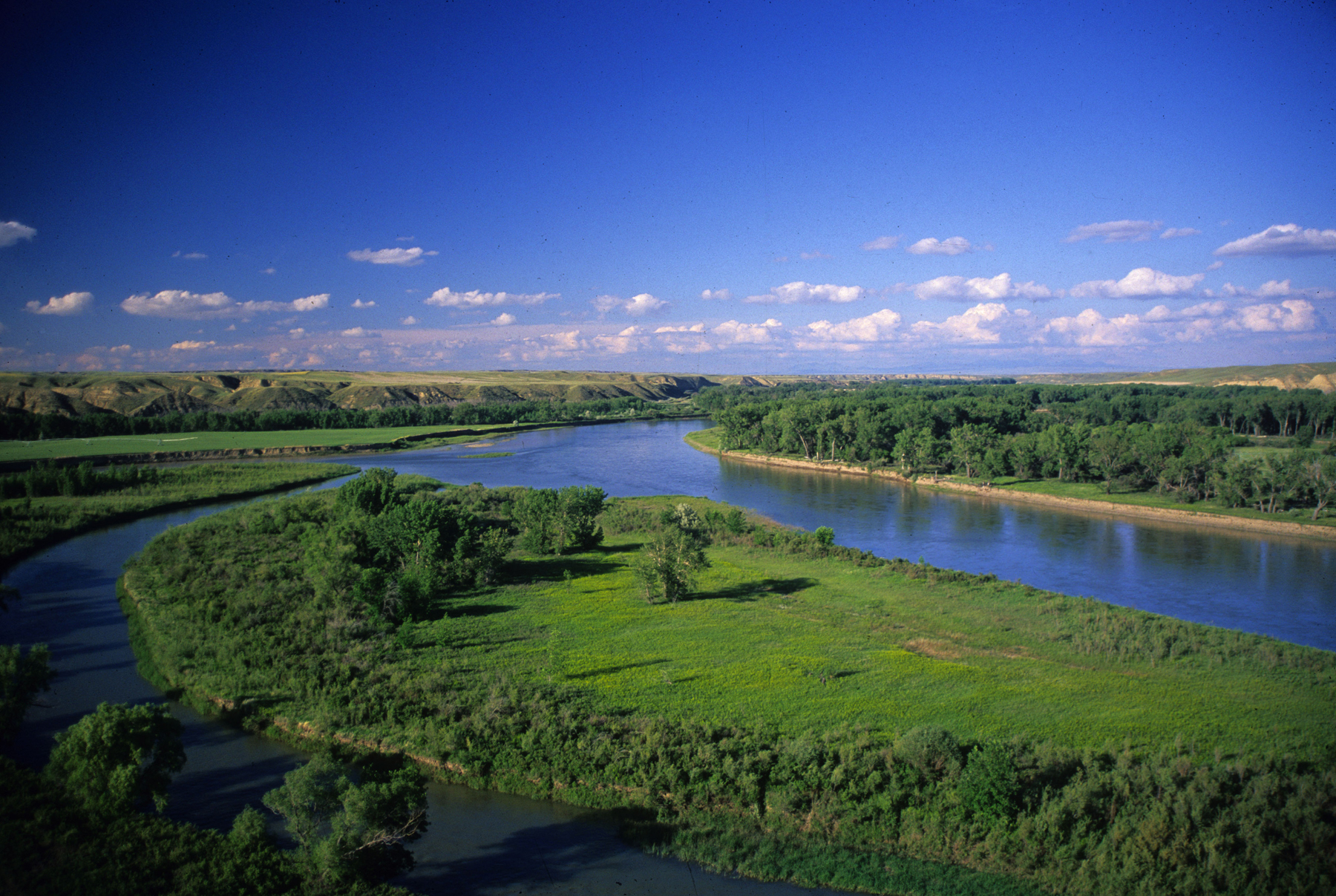 The Marias River enters the Missouri River on a bright summer day.