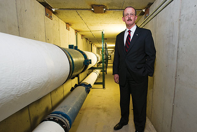 Robert Duringer, UM vice president for administration and finance, stands in a newer section of UM’s 2.81 miles of steam tunnels.