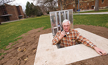 Heating plant supervisor Mike Burke pauses in one of the new lockable manholes that provide access to the steam tunnels.