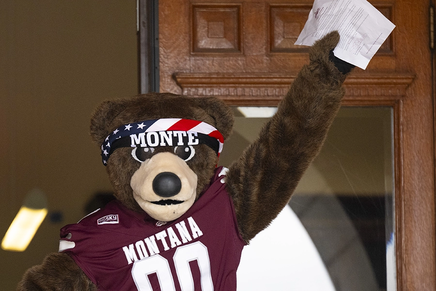 A photo of Monte holding a UM Griz Fridays proclamation. 