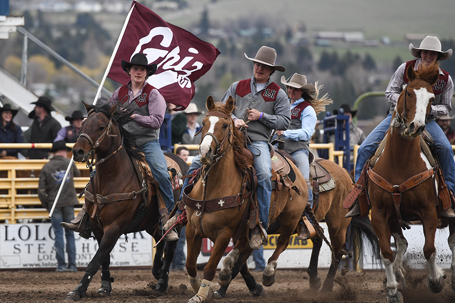 Collegiate UM Rodeo enters the arena with a Griz Flag 