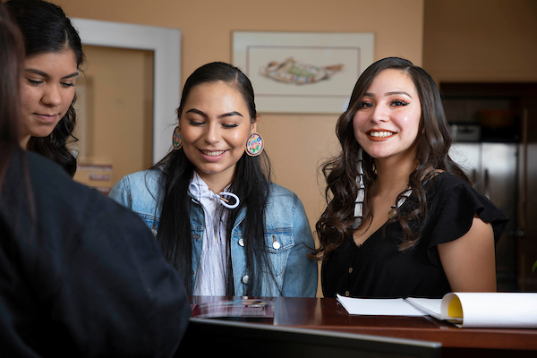 right to left Olivia Perez, Aislyn Baker, and Val Talks Different standing in the NAS office.
