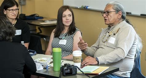 An elder speaks with students and faculty.