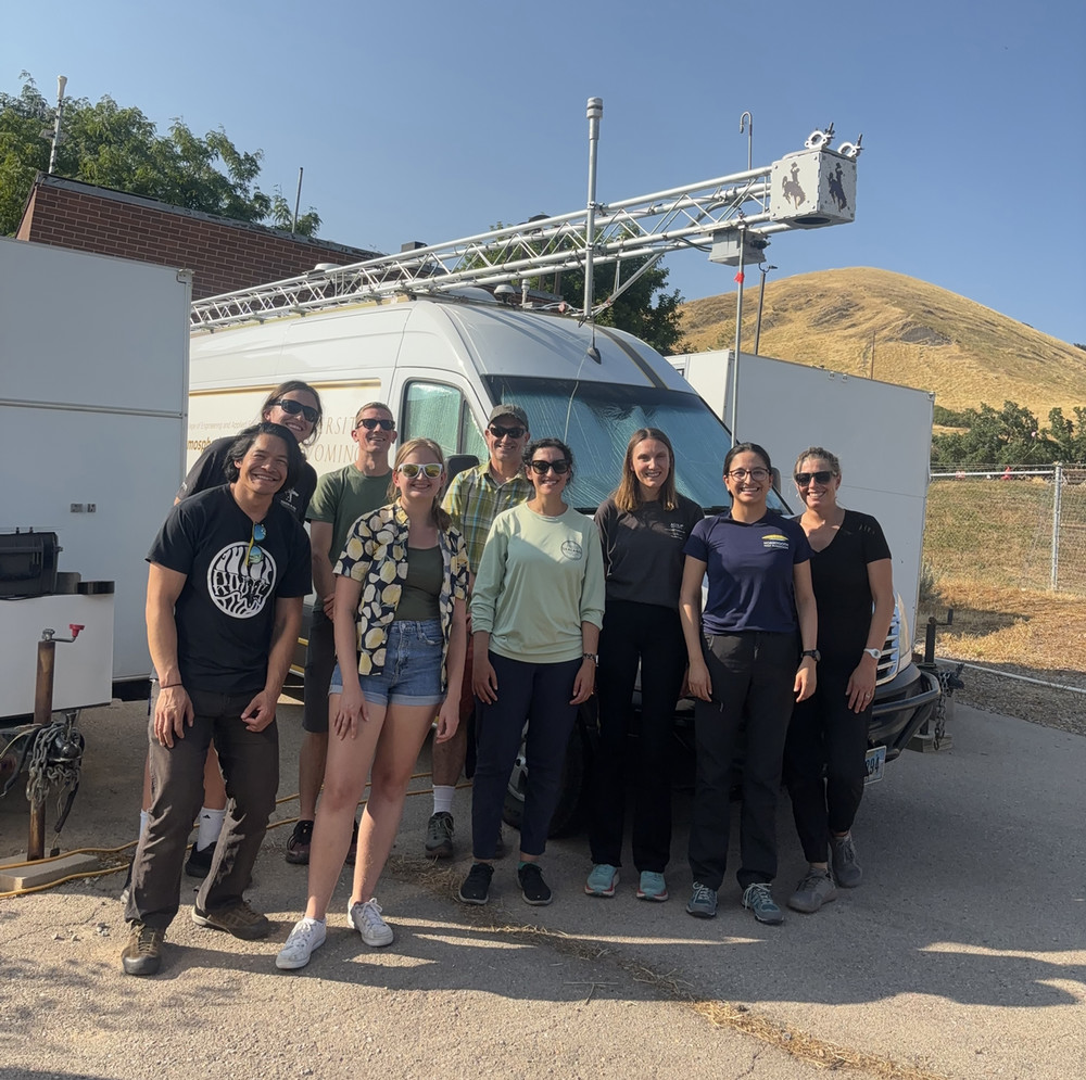 team posing in front of the u wy mobile lab during SLC-SOS 2024