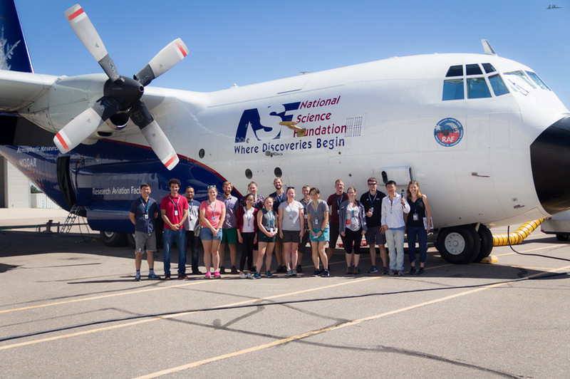 students posing in front of C-130 during WE-CAN