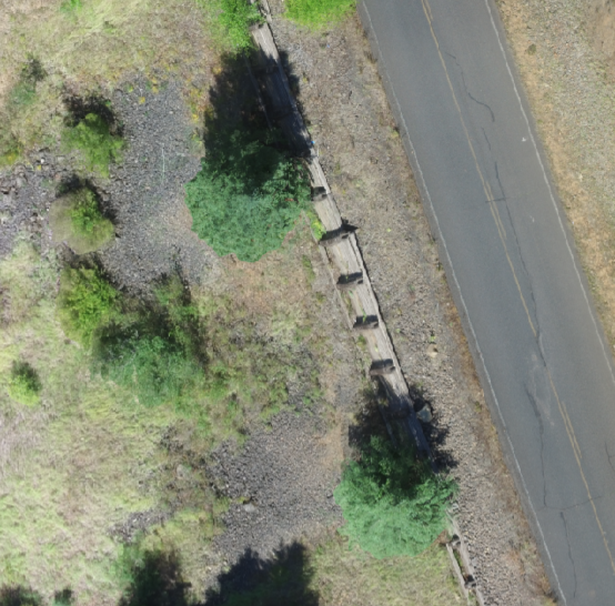 overhead view of timber wall holding up forest service road