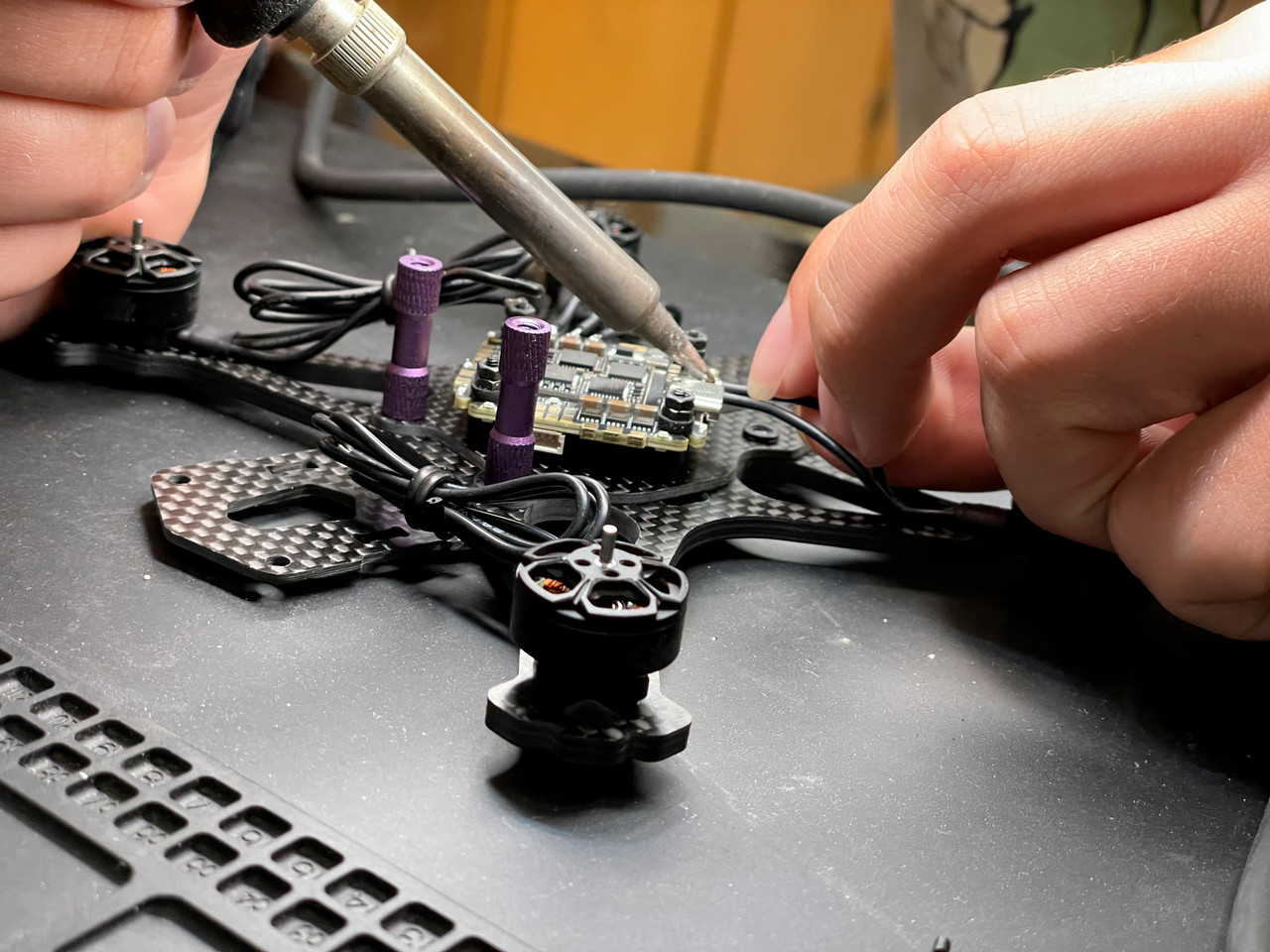 soldering iron being used on drone
