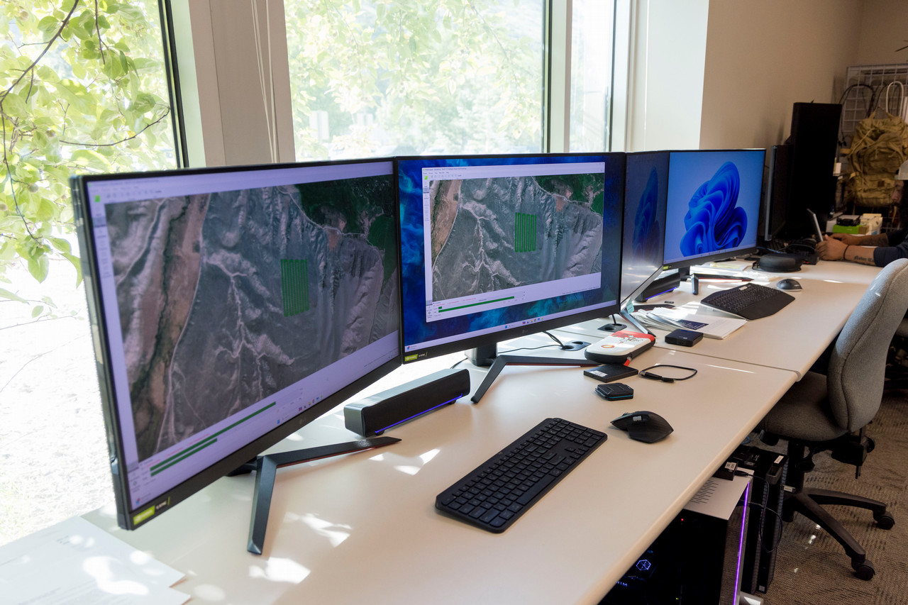Monitors in an office in front of a bright window