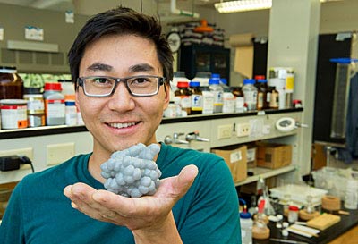 Casey holds a model of a triple helciate