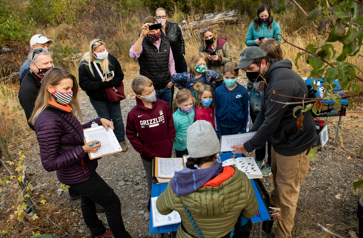 A group visits the banding station photographed from above.
