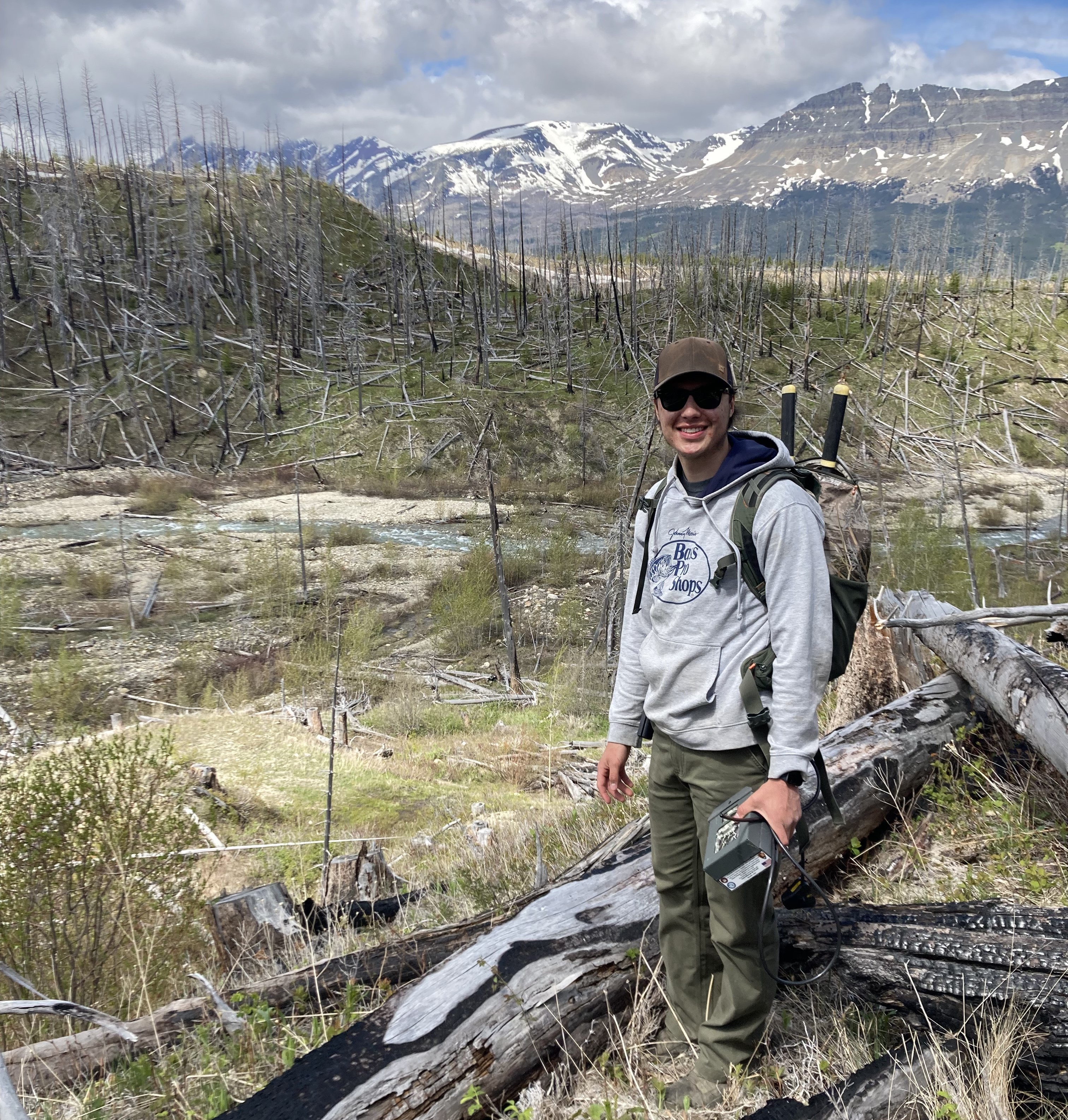 Landon Magee in field on Blackfeet Reservation conducting moose research