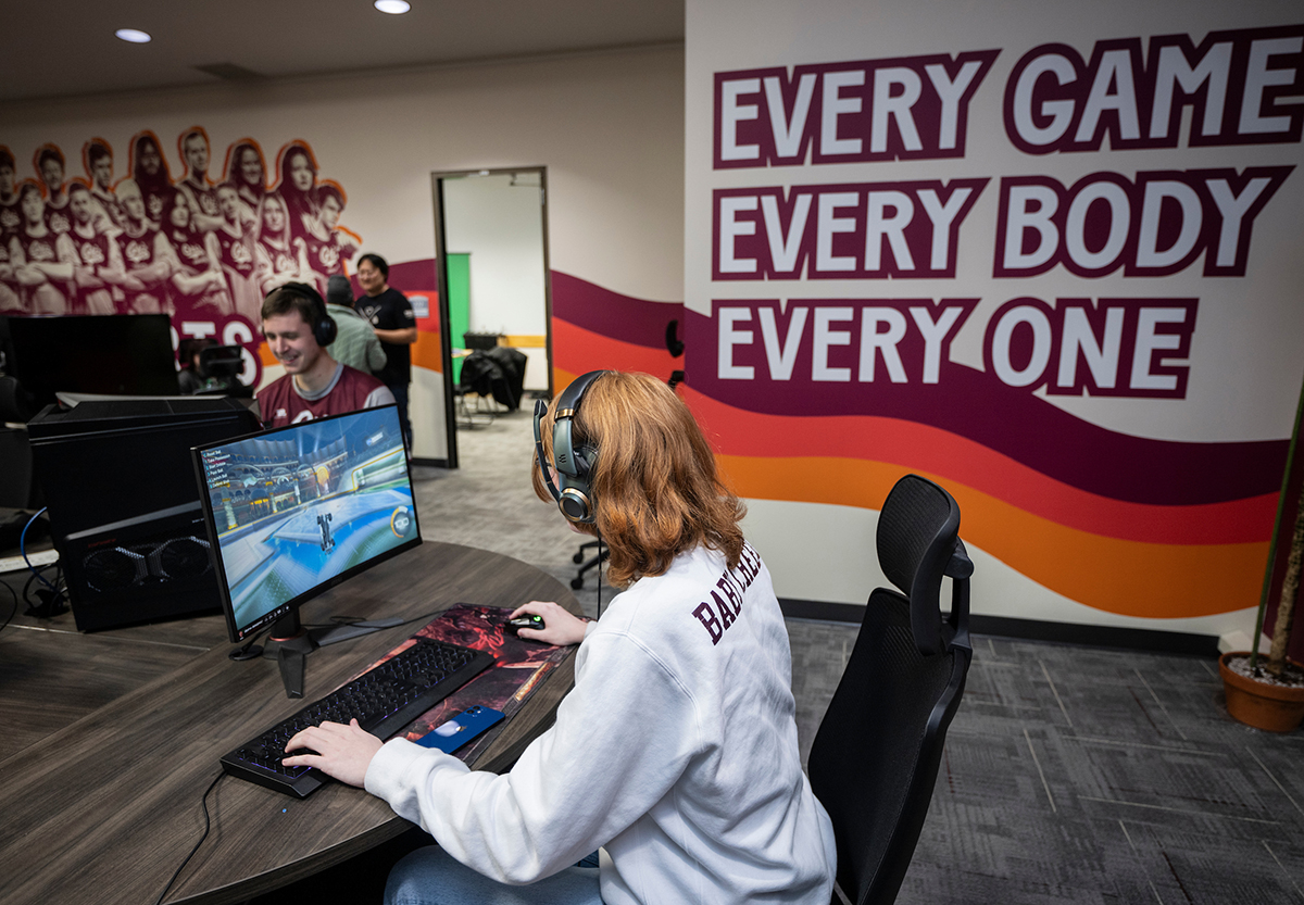 A student athlete plays a game in UM's Gaming Den