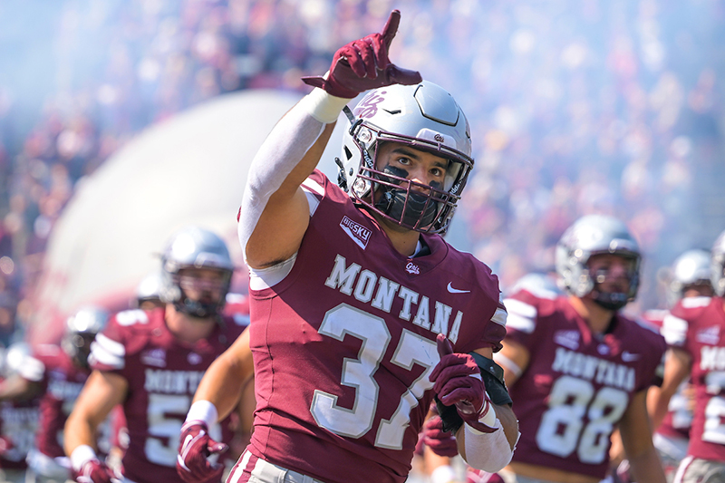 A Griz football player jersey 37 gives the No. 1 sign as he runs out of the tunnel