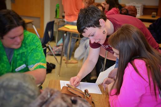 woman helping two students Jema helping two students