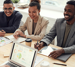Employees gather around a conference table for a meeting.