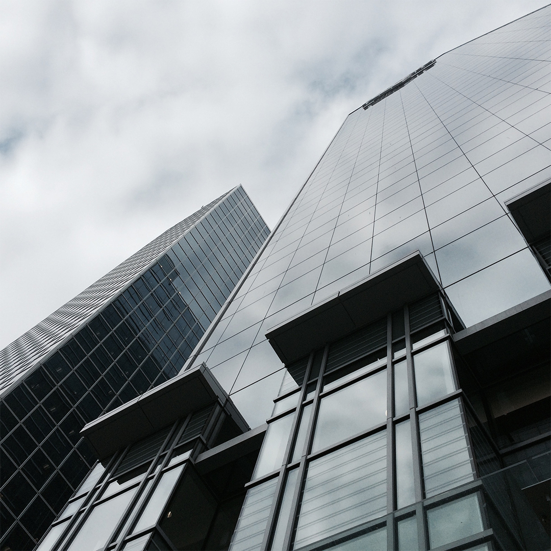 high contrast image of the side of a tall building, seen from below while looking up the face of it