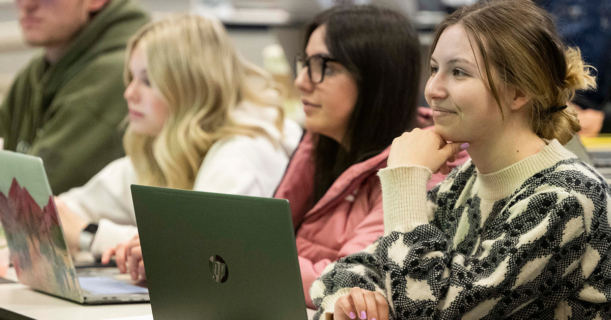 Women in business class attending a lecture.