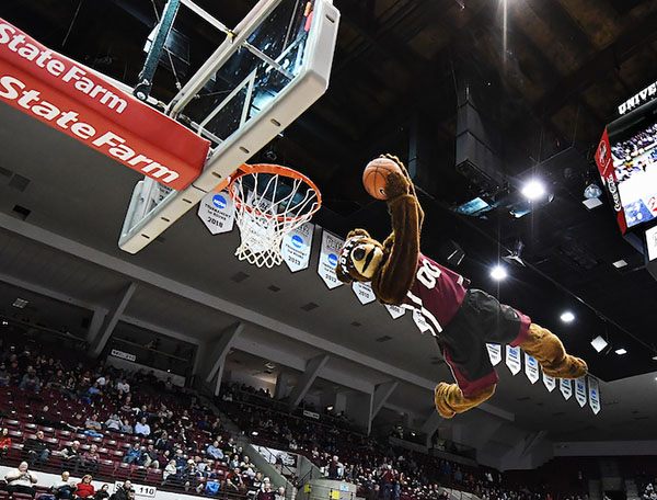 Monte the mascot acrobatically dunking a basketball
