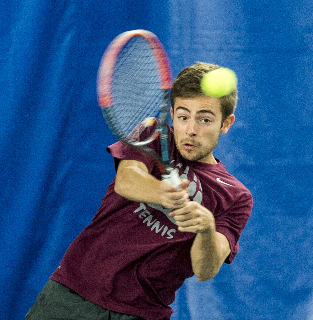 Tennis player hitting ball