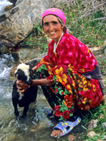 Elder woman petting a goat