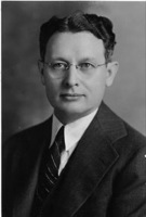 Black-and-white portrait of Reynold C. Fuson wearing glasses and a suit and tie.