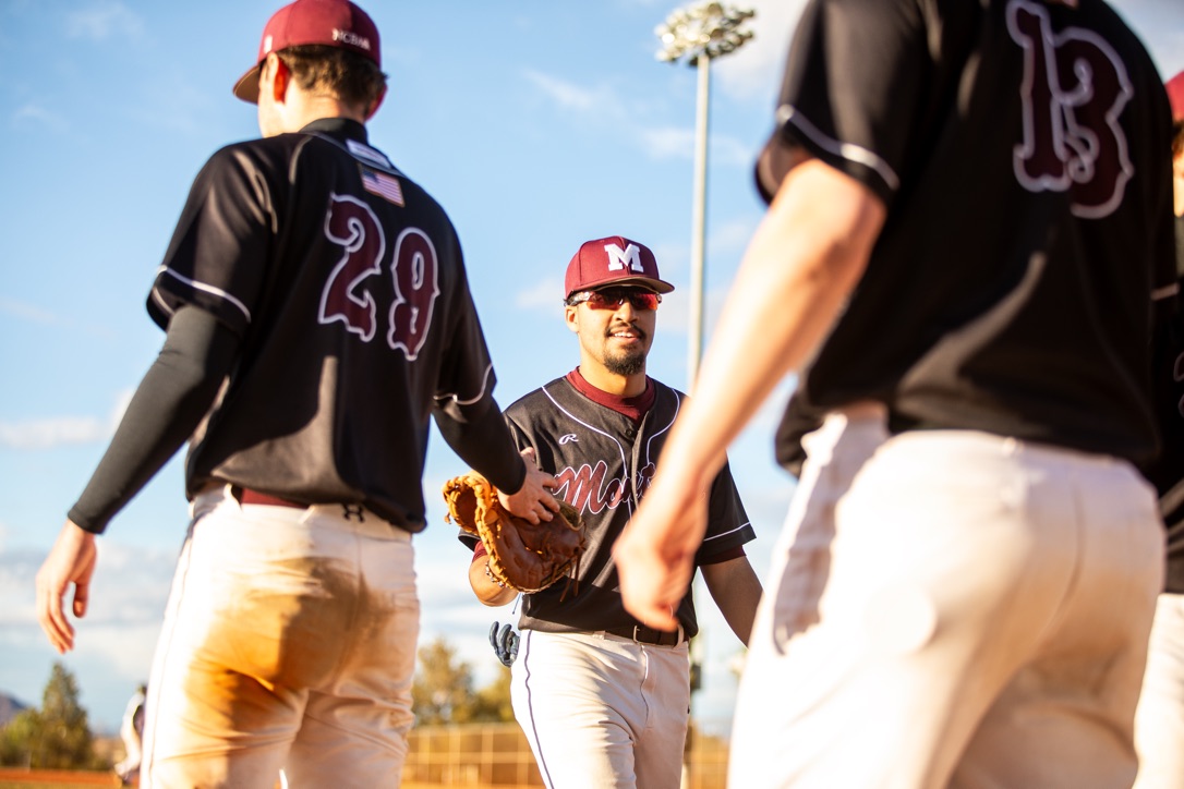 Griz Baseball Players Walking Past Each Other
