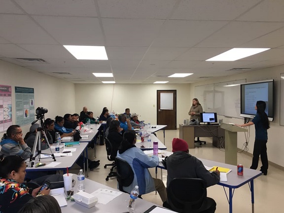 CLPP workshop in a classroom with two rows of students and a teacher and presenter