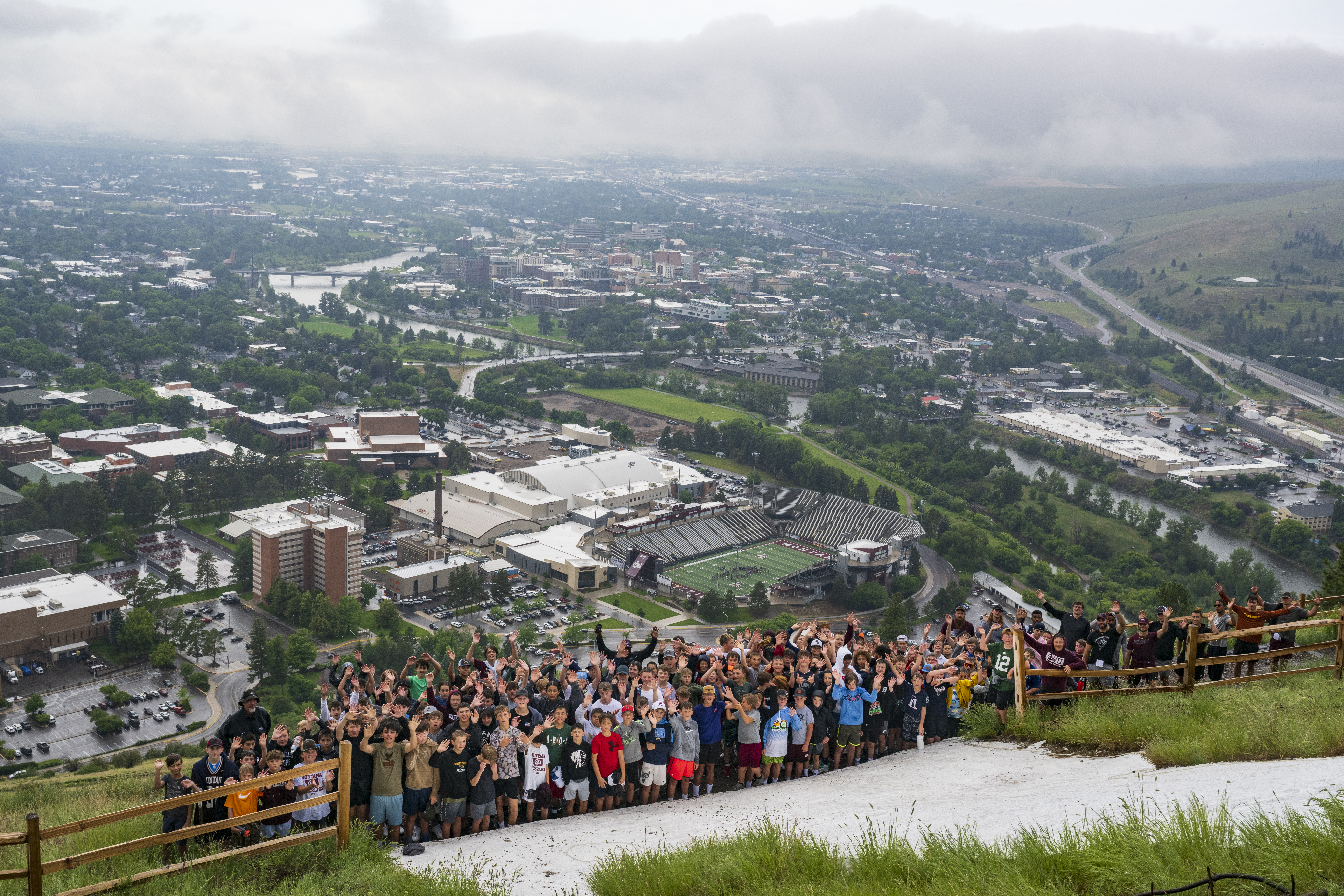 Group of kids smiling at the top of the M