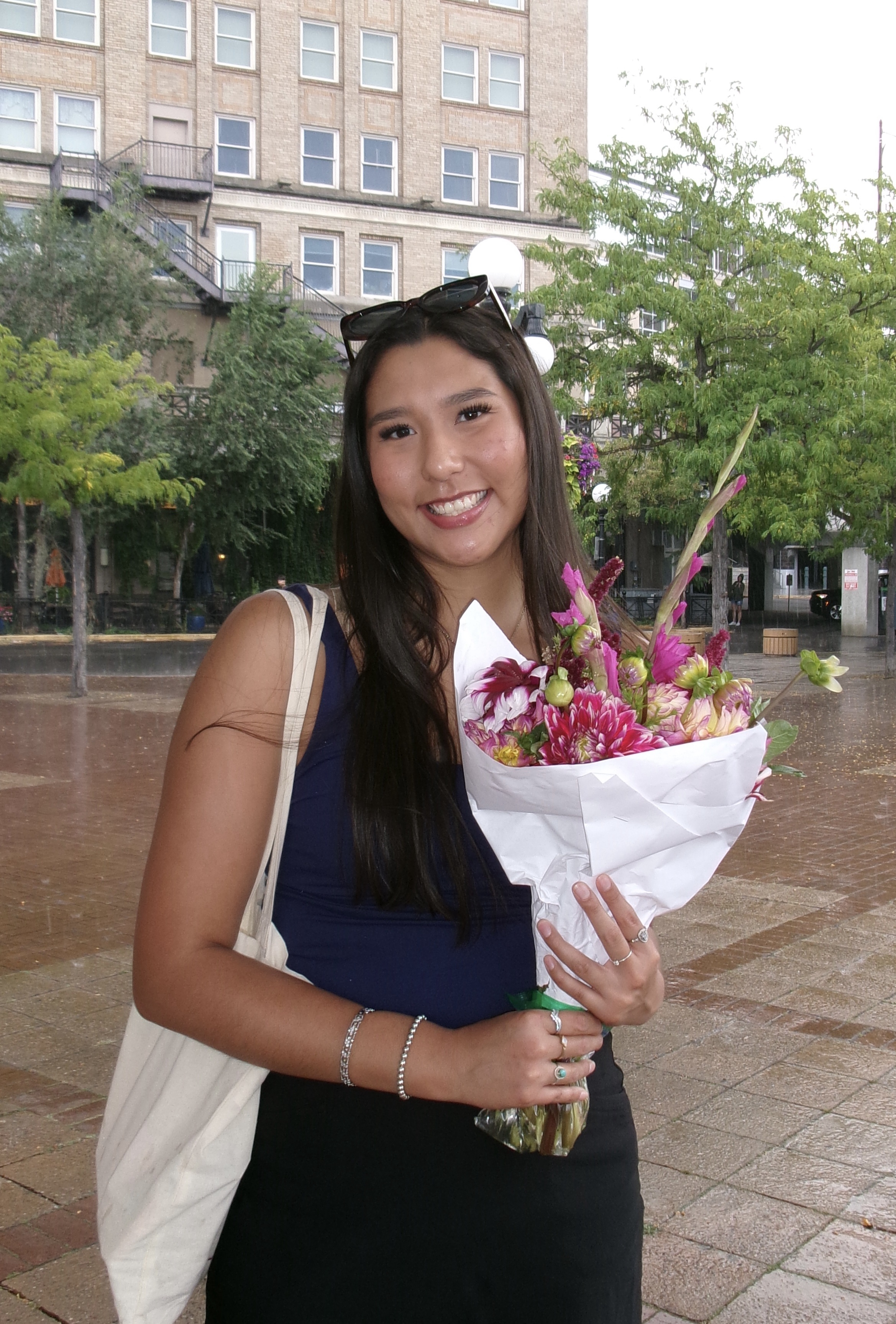 Photo of Susan Connelly, Wellbeing Office Assistant, holding some flowers.