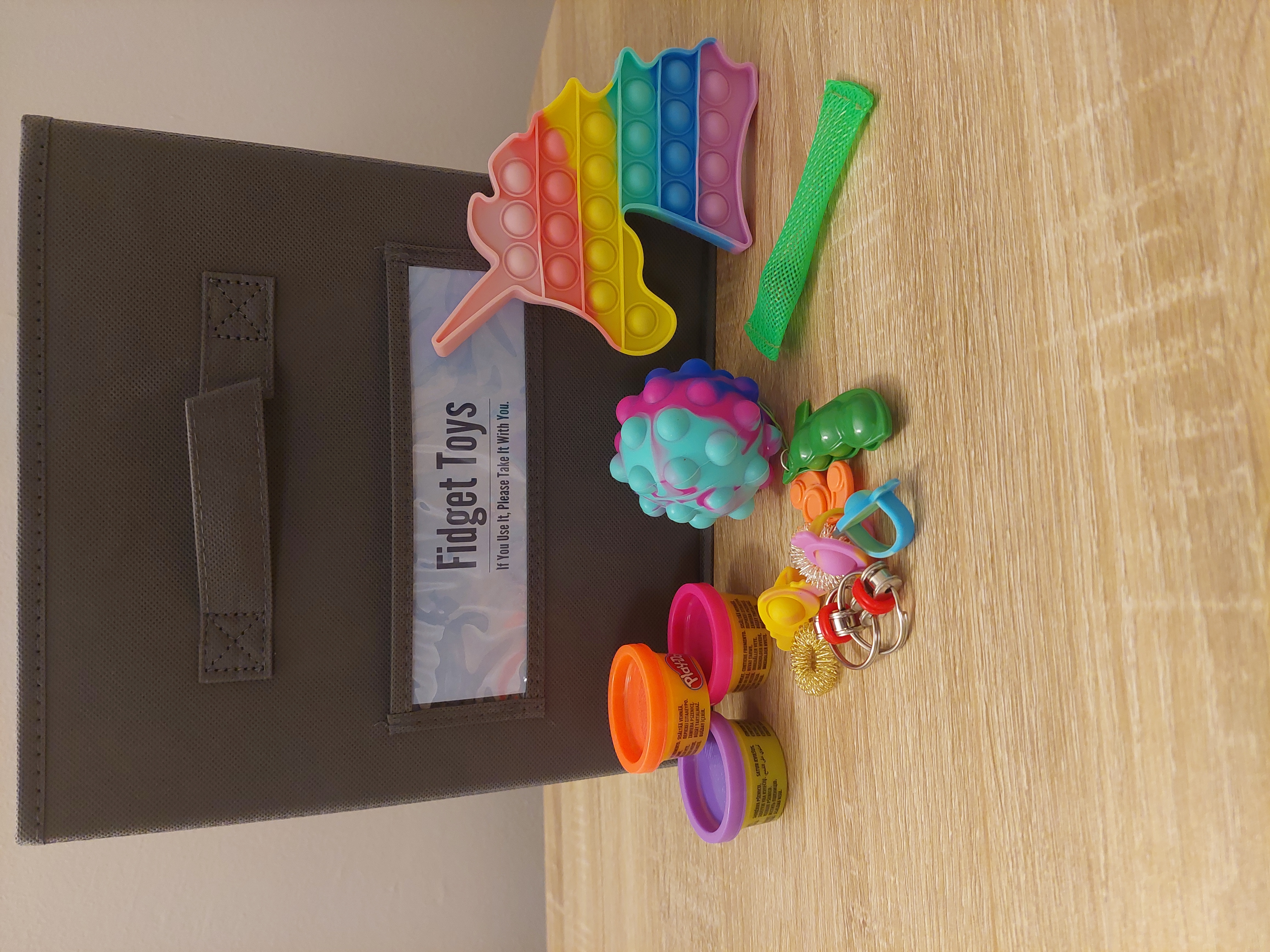 an array of fidget toys including a rainbow colored unicorn head