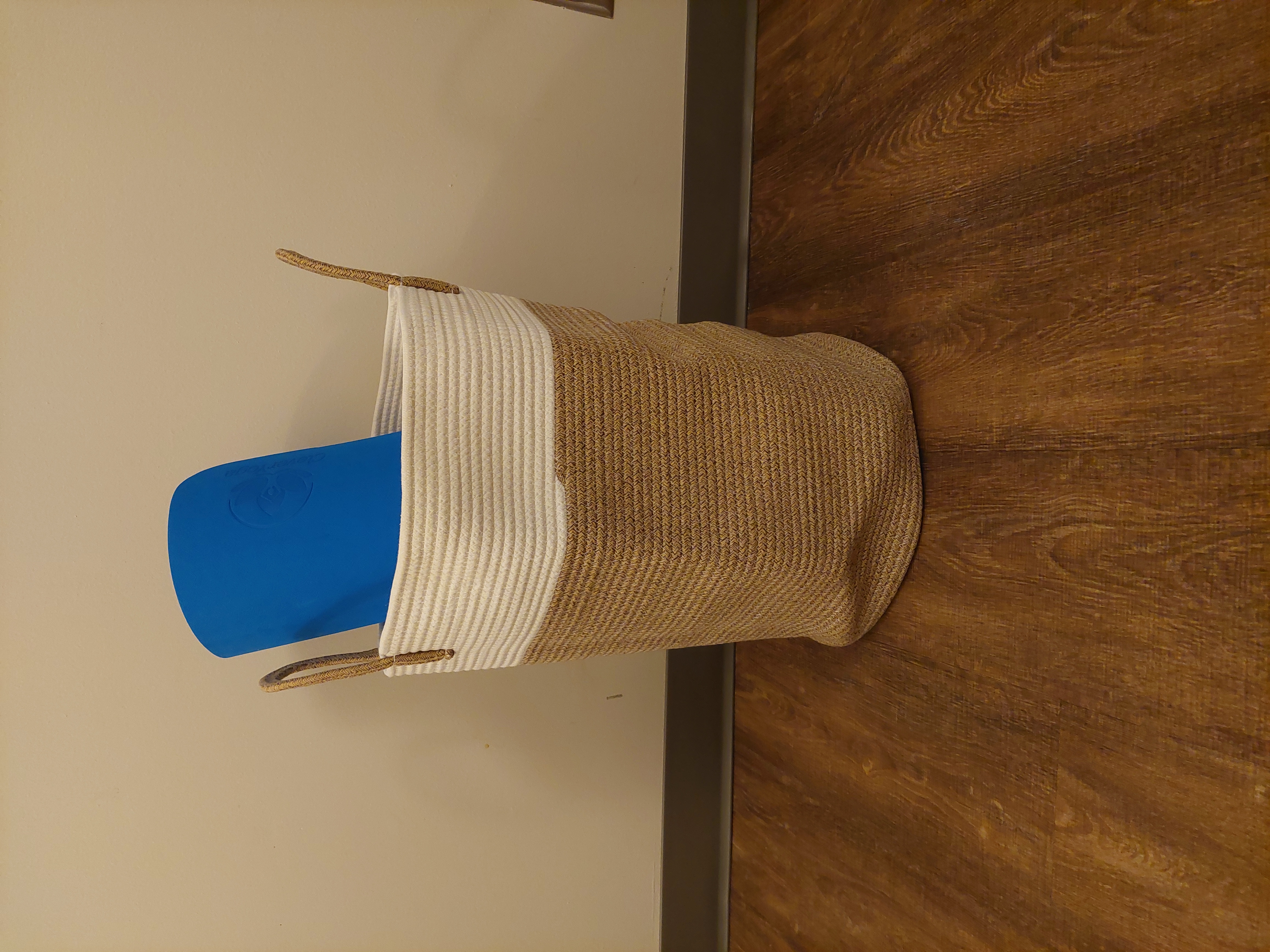 large bag containing yoga accessories with a mat sticking out of the top