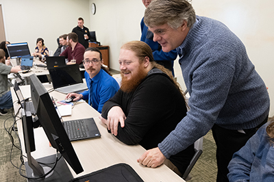 Jeff helping with people on computers