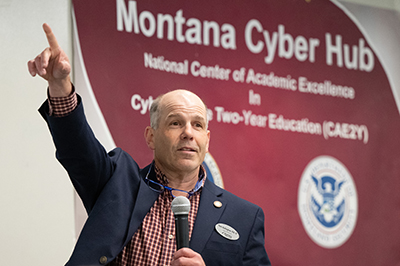 Tom Gallaghar in front of Montana Cyber Hub banner