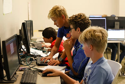 Kids Working on Computers During a Cyber Camp