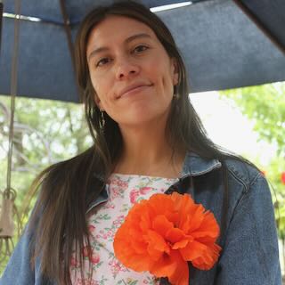 Headshot of ambey clark in front of an umbrella