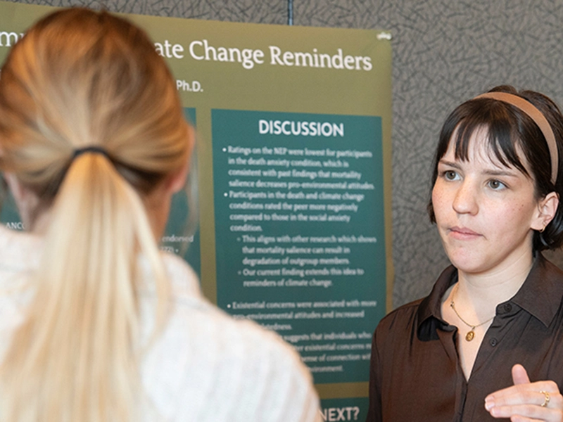 A person presenting their research to another person
