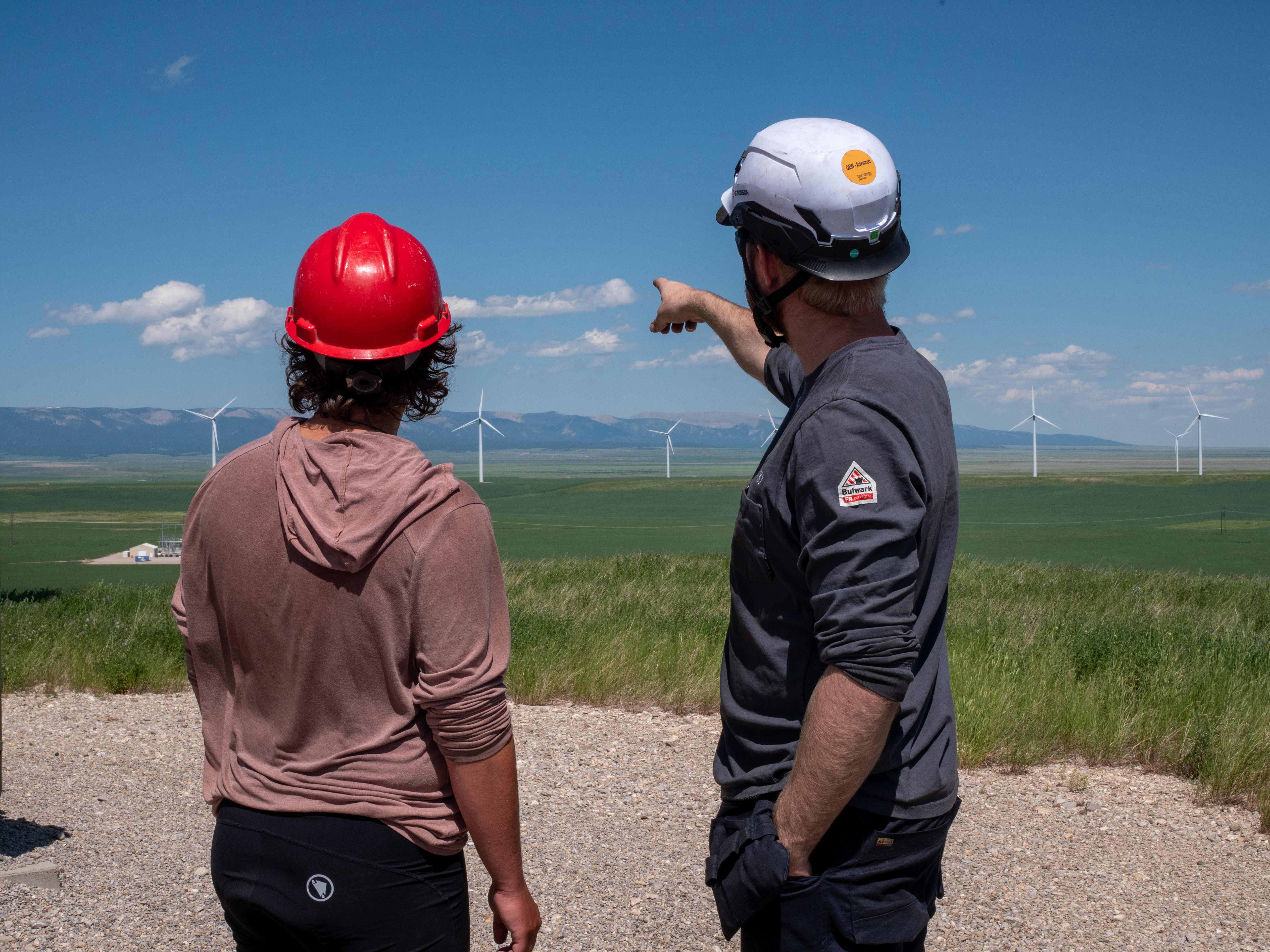 two people looking at windmills