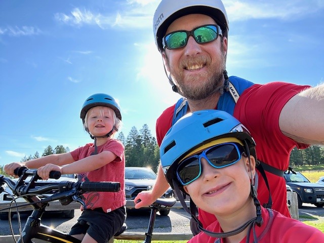 Thorson and two children on bicycles. 