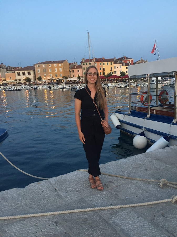 Renee standing by the water while abroad in Europe.
